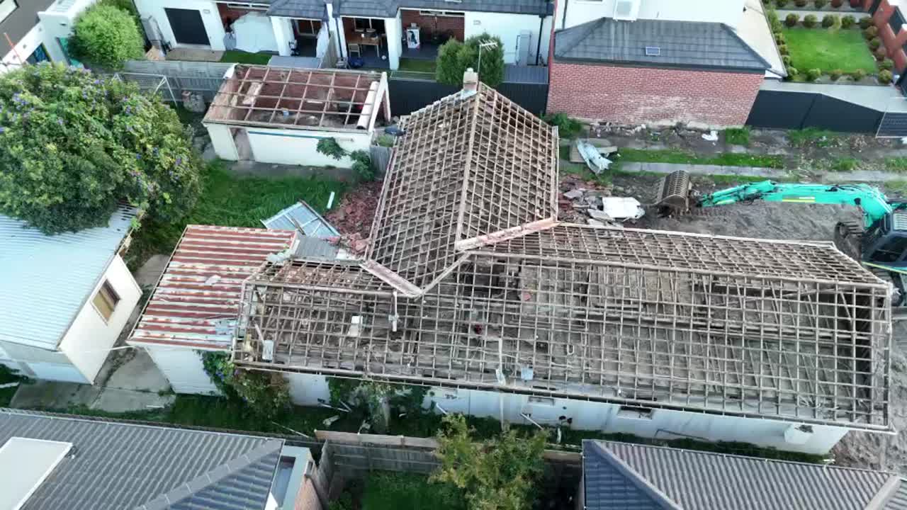 Aerial drone view of a heritage Tudor home undergoing partial demolition in inner Melbourne
